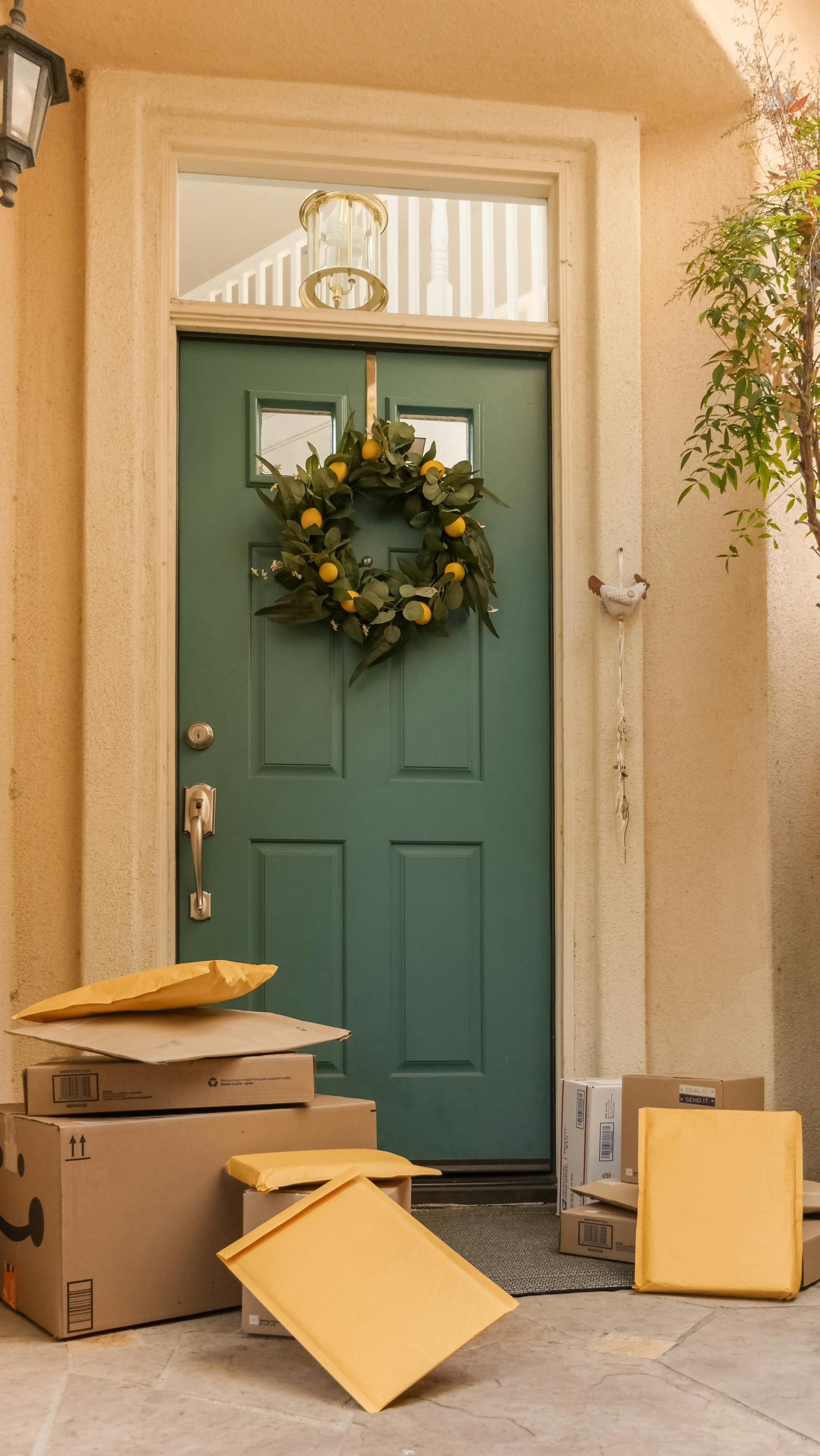 A welcoming entrance with a green wreath and several packages by the door.